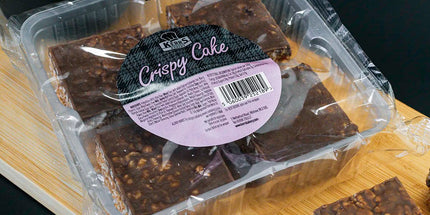 Packaged Crispy Cake on a wooden board with a dark background