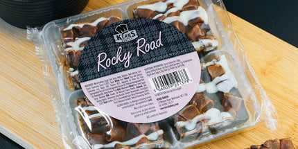 Packaged Rocky Road dessert on a wooden board with a black background