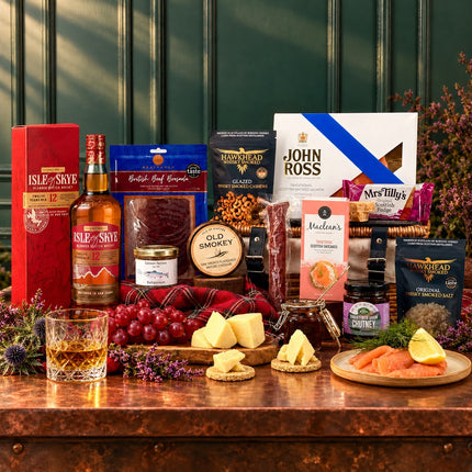 Isle of Skye 12 Year Old whisky with smoked salmon, cheese, cured meats, oatcakes and fudge arranged around a wicker hamper.