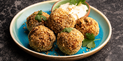 Vegetarian haggis bon bons served on a turquoise plate with a dip – serving suggestion