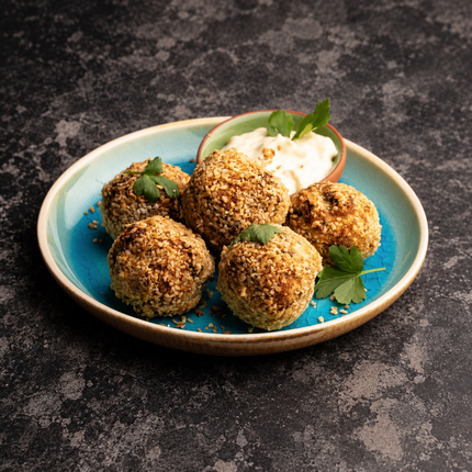 Vegetarian haggis bon bons served on a turquoise plate with a dip – serving suggestion